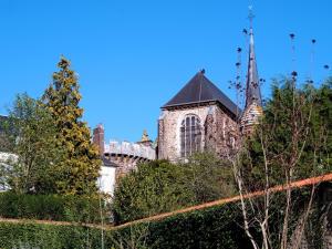 an old building with a tower and a church at La Maison d'hotes de Toucy in Toucy +4 photos
