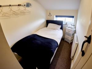 een kleine slaapkamer met een bed en een raam bij Tower View in Blackburn