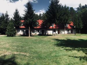 オルシュティネクにあるLeśna Chataの畑の赤屋根の家