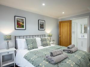 a bedroom with a bed with towels on it at The Townhouse in Tenby