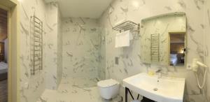 a white bathroom with a sink and a mirror at Family Home in Bukovel +7 photos
