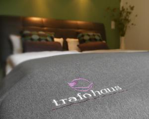 a bed with a hamiltonauts logo on top of it at Trafohaus am Kaiserbahnhof in Brühl