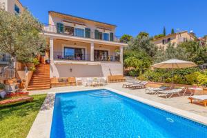 a villa with a swimming pool and a house at Casa Caterina in Port de Soller