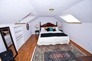 a bedroom with a large bed and a rug at Trail City Bed & Breakfast in Coolidge