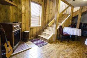 a room with a staircase and a table and a guitar at Trail City Bed & Breakfast in Coolidge