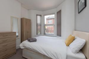 a bedroom with a white bed and a window at Townhouse @ Electricity Street Crewe in Crewe