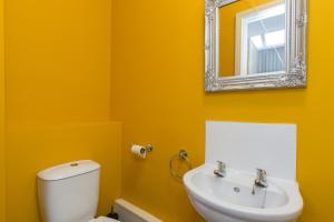 a bathroom with a white toilet and a mirror at Townhouse @ Electricity Street Crewe in Crewe