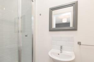 a bathroom with a shower and a toilet and a mirror at Crewe Rooms Brooklyn Street in Crewe
