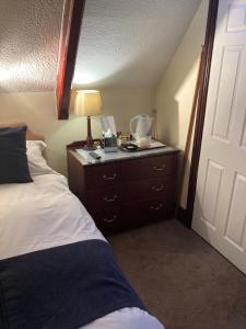 A bed or beds in a room at The Old School House Hotel 