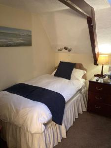 A bed or beds in a room at The Old School House Hotel 