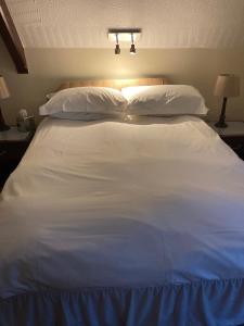 A bed or beds in a room at The Old School House Hotel 