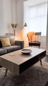 a living room with a couch and a coffee table at Townhouse @ Birches Head Road Stoke in Stoke on Trent