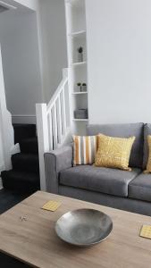 a living room with a couch and a table at Townhouse @ Birches Head Road Stoke in Stoke on Trent