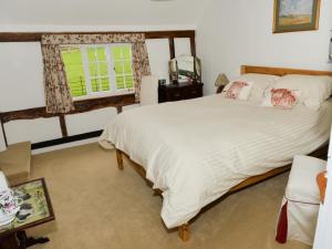 a bedroom with a large bed and a window at Twyford Farm B&B in Haywards Heath
