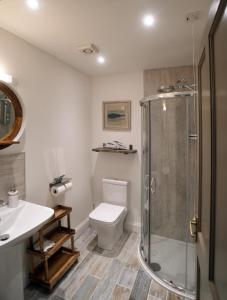 a bathroom with a shower and a toilet and a sink at Skye Photo Centre in Camastianavaig