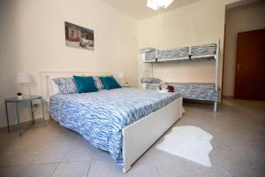 a bedroom with a bed and two bunk beds at La casa di Nana’ locazione turistica in Palermo