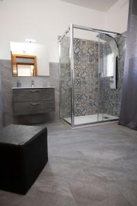 a bathroom with a shower and a sink and a mirror at La casa di Nana’ locazione turistica in Palermo