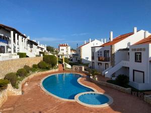 a swimming pool in a courtyard of a building at Top villa with extraordinary view of Atlantic in São Martinho do Porto
