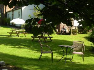 a group of picnic tables and chairs in the grass at Stanley Arms Hotel in Seascale