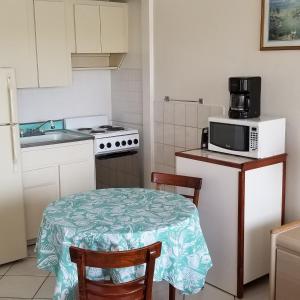 a small kitchen with a table and a microwave at Bimini Motel in Hollywood