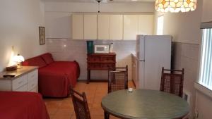 a living room with a red couch and a table at Bimini Motel in Hollywood