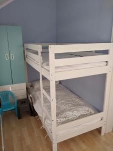 a white bunk bed in a room with a blue wall at Zur ForsHütte in Braunlage