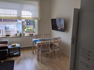 a kitchen and dining room with a table and chairs at Zur ForsHütte in Braunlage