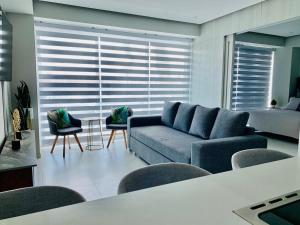 a living room with a blue couch and chairs at Nautico departamento Marina Vallarta in Puerto Vallarta