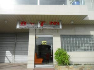 a store with a sign on the front of a building at BnT Inn in Mactan