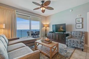 a living room with a couch and a tv at Sterling Breeze 2 in Panama City Beach