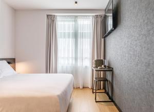 Postel nebo postele na pokoji v ubytování Hotel Forum Ceao