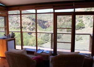 a living room with a large window with a view at Sederkloof Lodge in Studtis