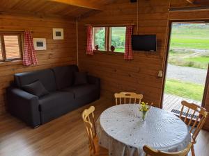 a living room with a table and a couch at Stóra-Vatnshorn in Búðardalur