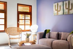 a living room with a couch and a table at Boutique Homes Willemstad City Centre in Willemstad