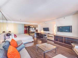 a living room with a couch and a tv at Beautiful High Rise Condo-307 in Las Vegas +1 photo