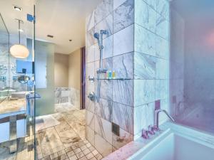 a bathroom with a shower and a tub and a sink at Beautiful High Rise Condo-307 in Las Vegas