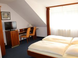 Postel nebo postele na pokoji v ubytování City Hotel Stuttgart
