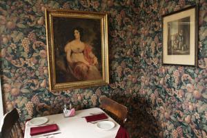 a dining room with a table and a painting on the wall at Surfside Inn in Hubbards