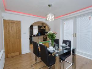 a dining room with a table and chairs at Sycamore House in Leeds