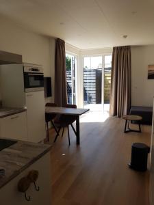 a kitchen and living room with a table and a living room at Vakantiehuis Huisje 31 Zoutelande in Zoutelande