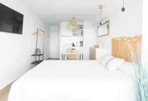 A bed or beds in a room at Sugar Beach Boutique Studio