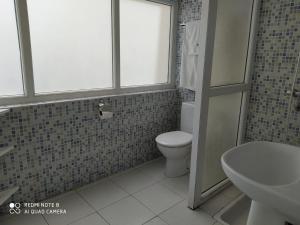 a bathroom with a toilet and a sink at Hôtel Petite Suède in Agadir