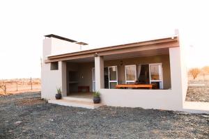 uma casa branca com uma janela ao lado em Donkieshoek Accommodation & Campsite, Calvinia em Calvinia