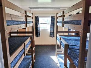 a room with four bunk beds in a bus at X Adventure in Horsford