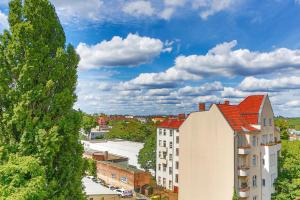 un grand bâtiment blanc avec un toit rouge dans l'établissement primeflats - Apartments Panke Berlin-Wedding, à Berlin