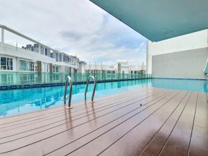 a swimming pool with two metal rails next to a building at Kuala Lumpur Central Residences by BeeStay Management in Kuala Lumpur