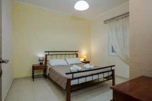 A bed or beds in a room at Vasso Apartments 3