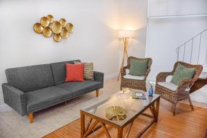 a living room with a couch and two chairs at Coral Reef at Key Biscayne in Miami