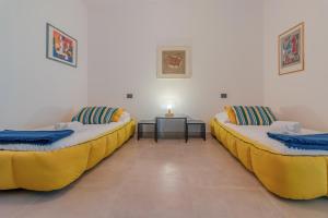 twee bedden in een kamer met een tafel bij CASA CAROLINA Mare, Comfort e Relax in Camogli