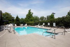 a large swimming pool with chairs at Holiday Inn Express Hotel & Suites Bethlehem Airport/Allentown area, an IHG Hotel in Bethlehem